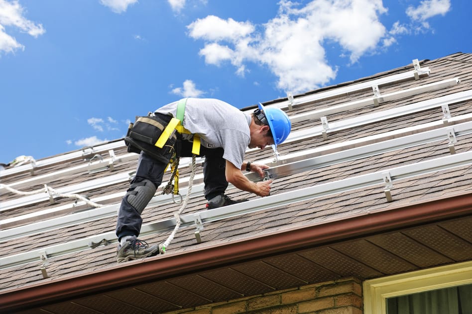 photodune-204073-man-working-on-roof-installing-rails-for-solar-panels-s